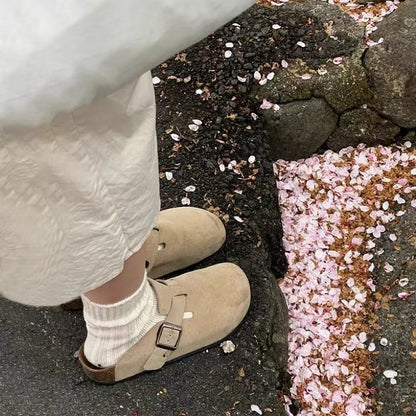 Ladies wear flip-flops with their heads covered